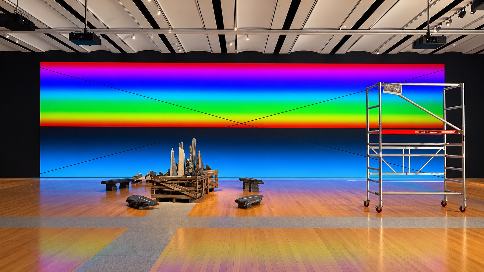 Exhibition hall with a large colour-gradient LED wall and a sculptural installation in the foreground